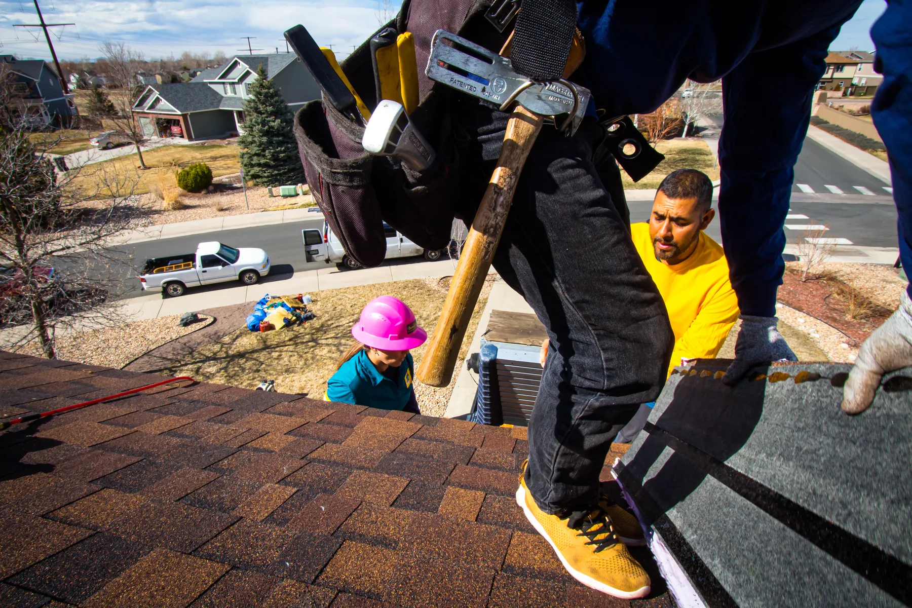 BossLady crew installing asphalt shingles on a Colorado roof